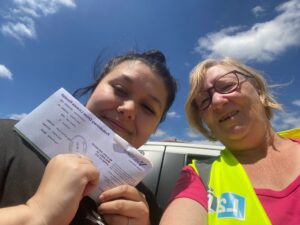 An L2P volunteer mentor with a learner holding their probationary license.